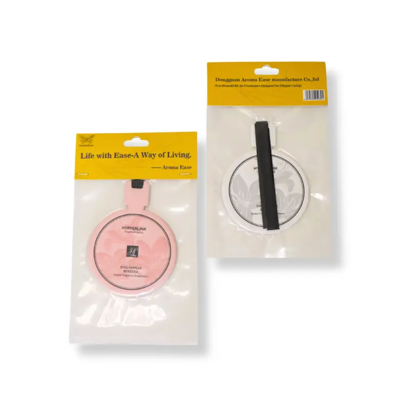 Back view of round paper air freshener packaging showing hanging ribbon and embossed craft