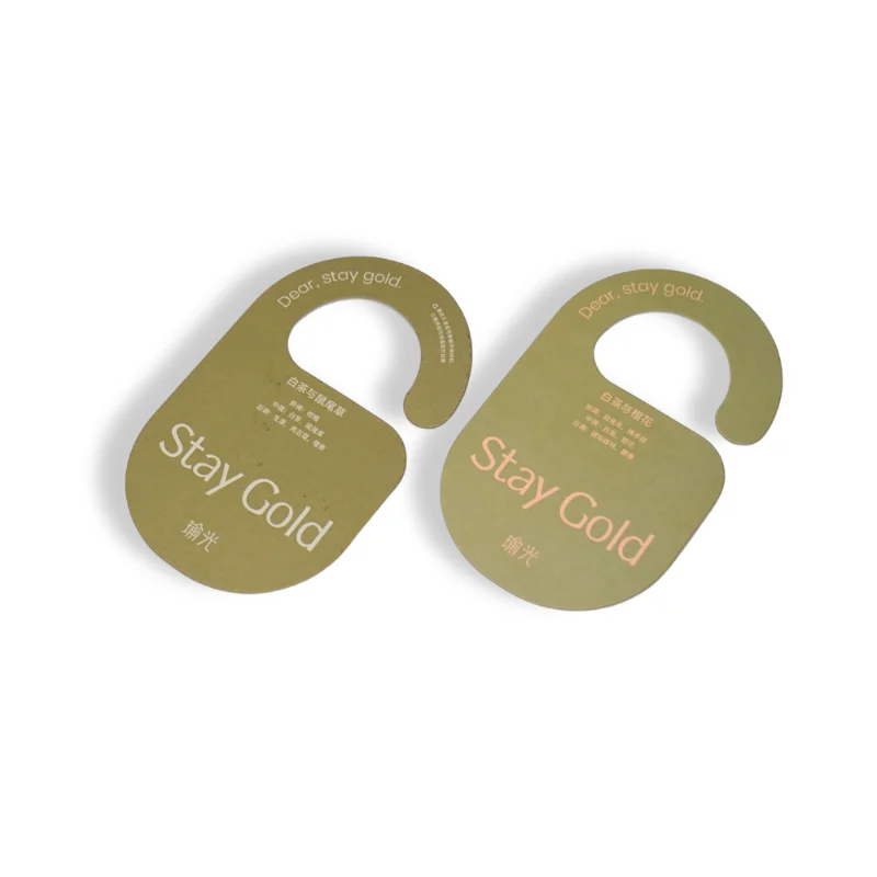 Door-hanger style Stay Gold air freshener with minimalist fragrance design