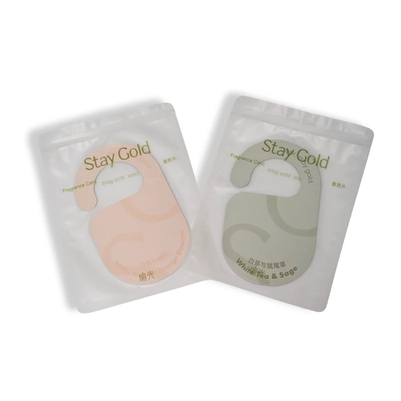 Stay Gold scented door hanger air freshener packaged in white pouch